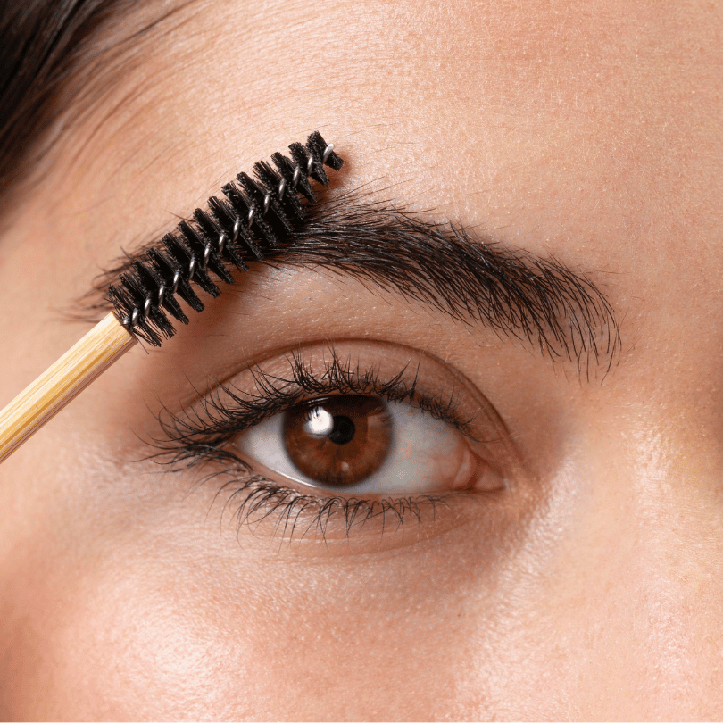Woman Applying Moisturizer on Her Face Using Brush